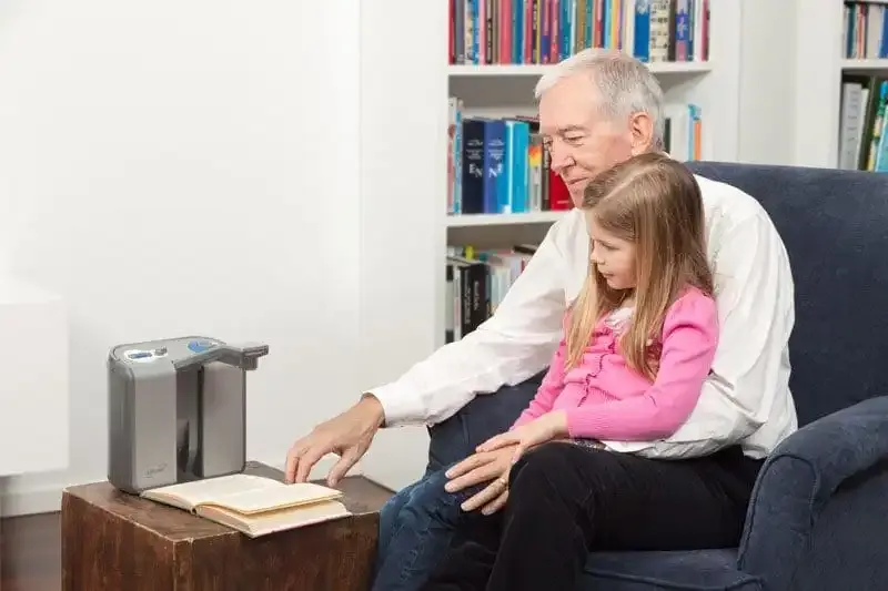 Elderly man reading with a child.