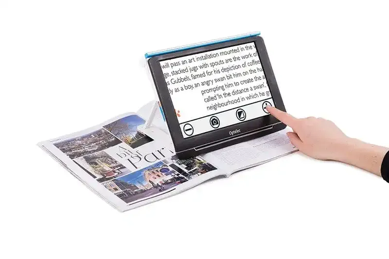 Digital magnifier over magazine with hand interaction.